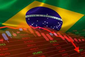 bandeira do Brasil com gráficos da bolsa caindo