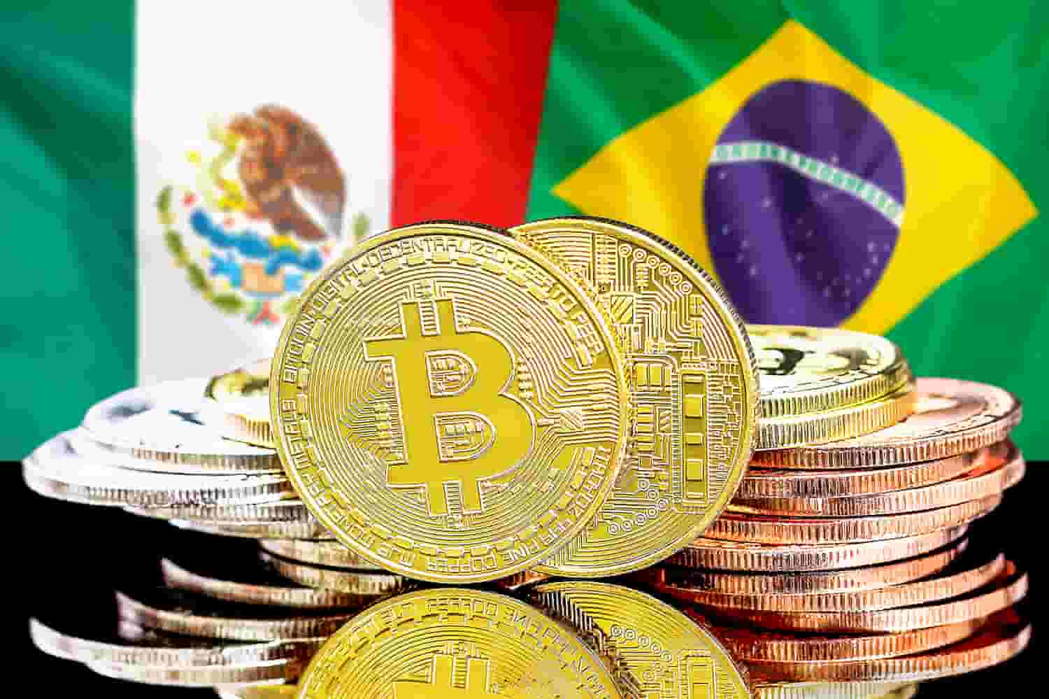 Moedas de bitcoin e bandeiras do Brasil e México ao fundo